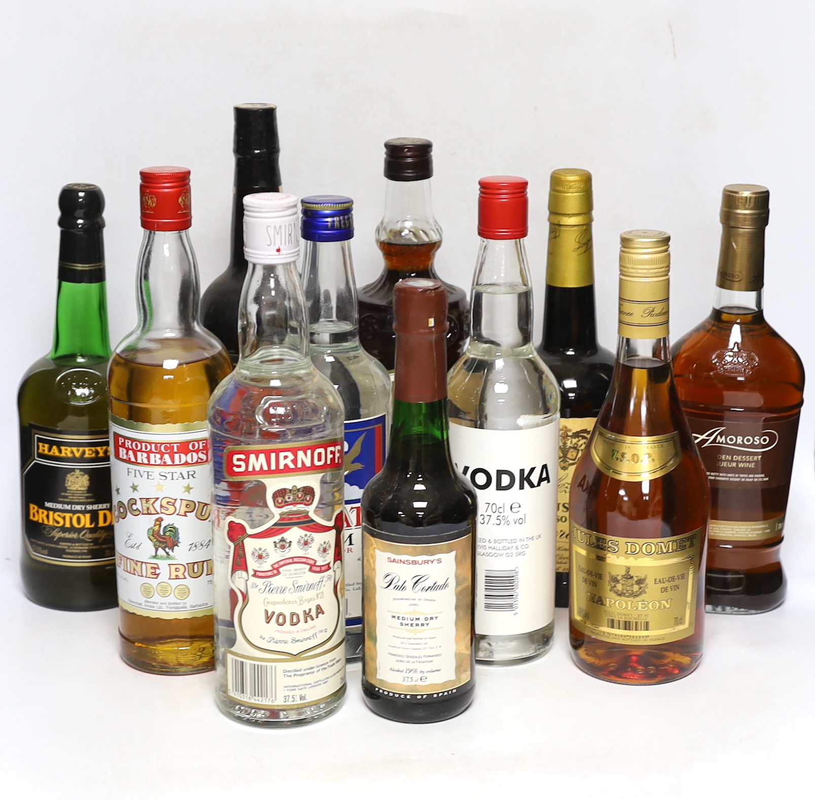 A selection of spirits, brandies and sherries to include Smirnoff, Jules Dumet, Cockspur etc